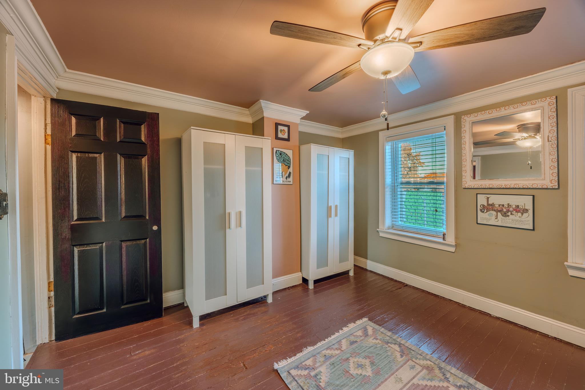 3450 Keswick Road Baltimore, MD 21211 - Photo 19 of 35 a view of livingroom with hardwood floor and ceiling fan