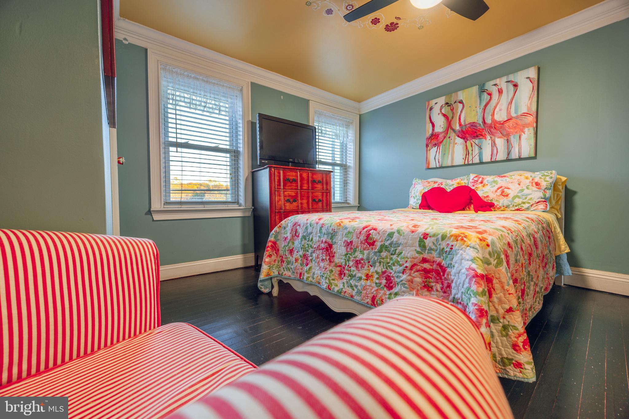 3450 Keswick Road Baltimore, MD 21211 - Photo 22 of 35 a bedroom with a bed and a chandelier