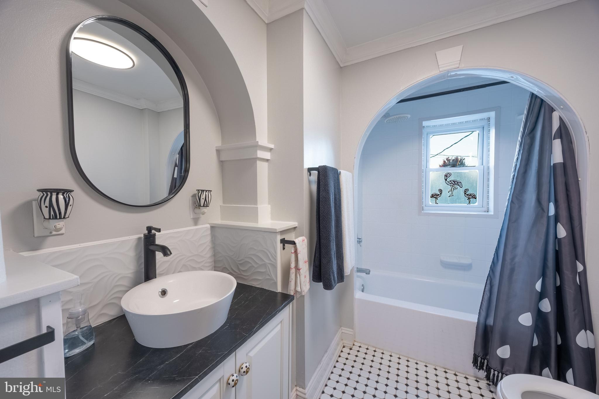 3450 Keswick Road Baltimore, MD 21211 - Photo 23 of 35 a bathroom with a sink a toilet and a bathtub