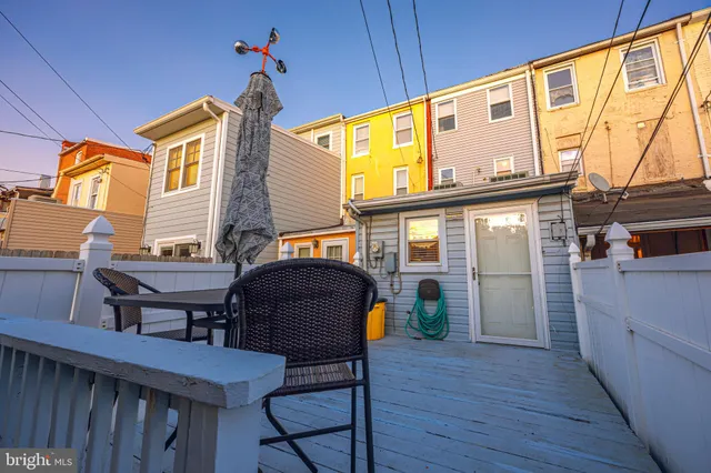 a view of a chairs and table in the balcony