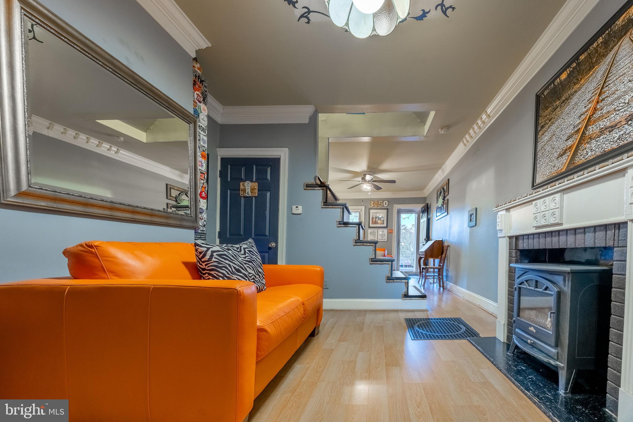 3450 Keswick Road Baltimore, MD 21211 - Photo 8 of 35 a living room with furniture a fireplace and a table