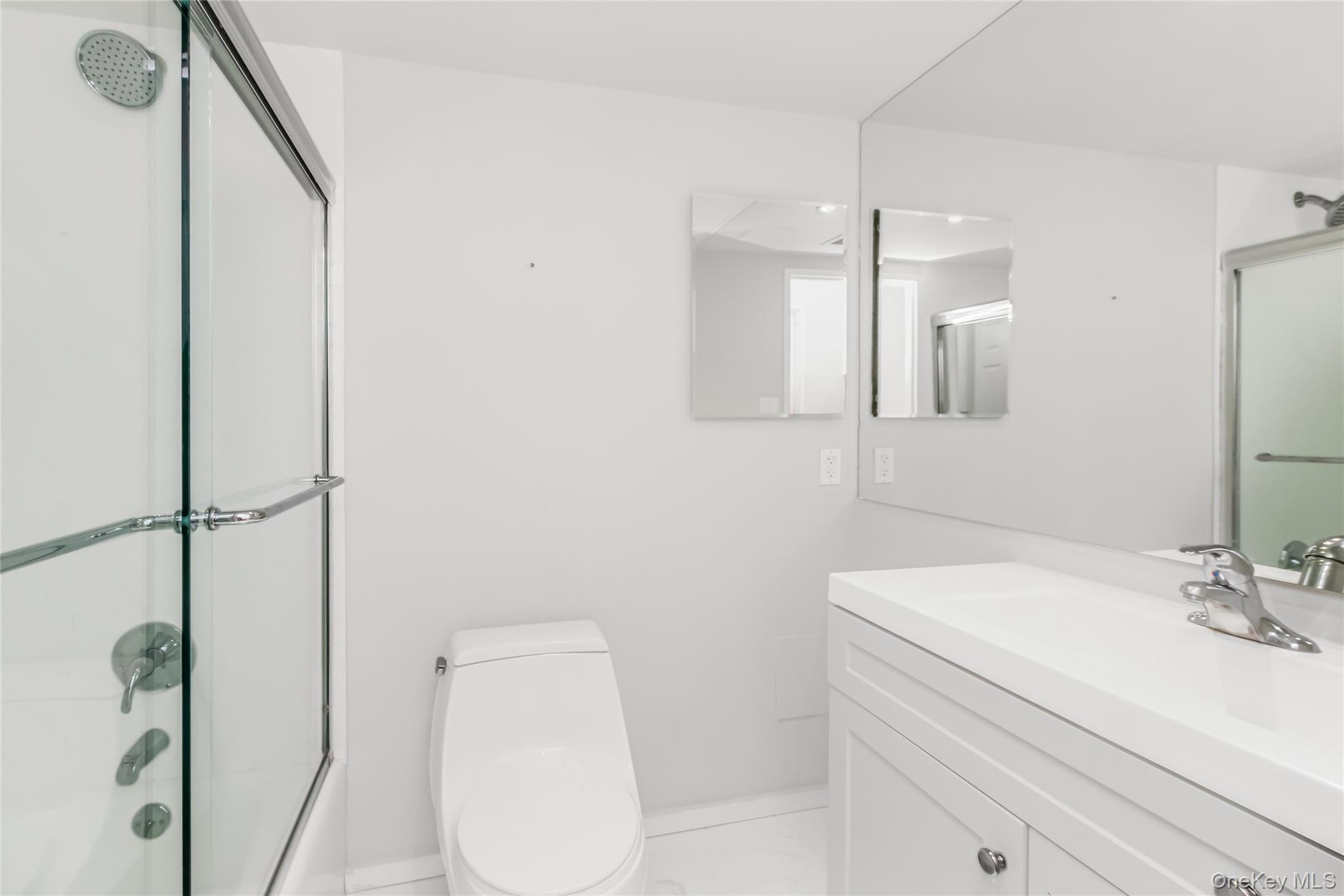 2287 Johnson Avenue, Unit 5F Bronx, NY 10463 - Photo 15 of 22 a bathroom with a sink a toilet and shower