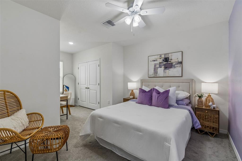 33083 Frosted Clover Way Wesley Chapel, FL 33545 - Photo 12 of 70 a bedroom with a bed and chair