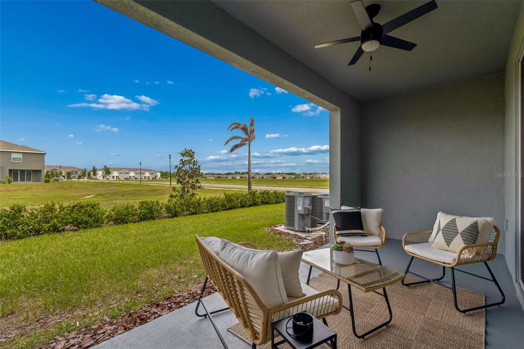 33083 Frosted Clover Way Wesley Chapel, FL 33545 - Photo 16 of 70 a view of a patio with chairs and a table