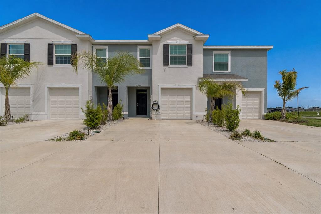 33083 Frosted Clover Way Wesley Chapel, FL 33545 - Photo 20 of 70 a front view of a house with a yard and garage
