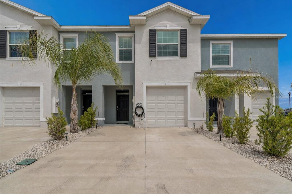 33083 Frosted Clover Way Wesley Chapel, FL 33545 - Photo 2 of 70 a front view of a house with garden