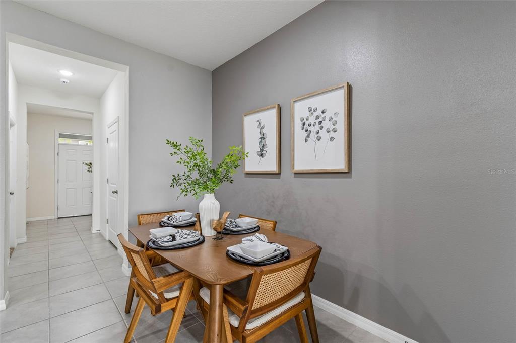 33083 Frosted Clover Way Wesley Chapel, FL 33545 - Photo 25 of 70 a view of a dining room with furniture and wooden floor