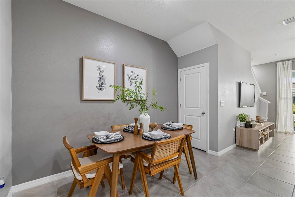 33083 Frosted Clover Way Wesley Chapel, FL 33545 - Photo 26 of 70 a view of a dining room with furniture and a potted plant