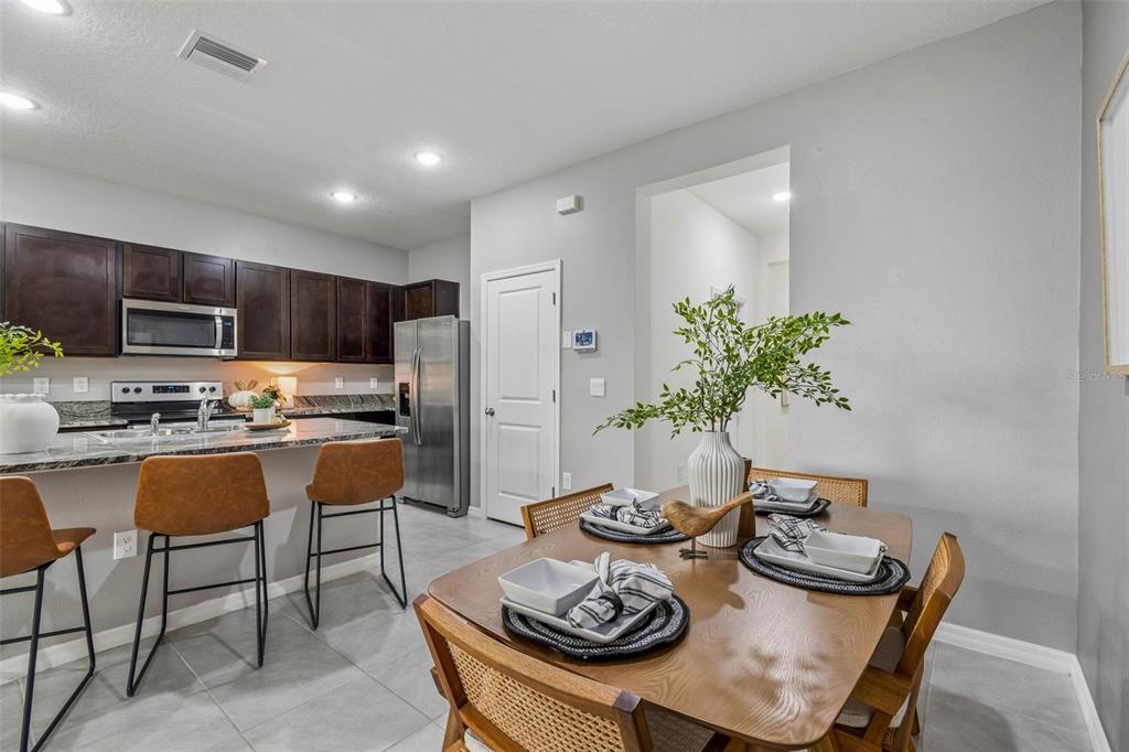 33083 Frosted Clover Way Wesley Chapel, FL 33545 - Photo 27 of 70 a kitchen with a table and chairs in it