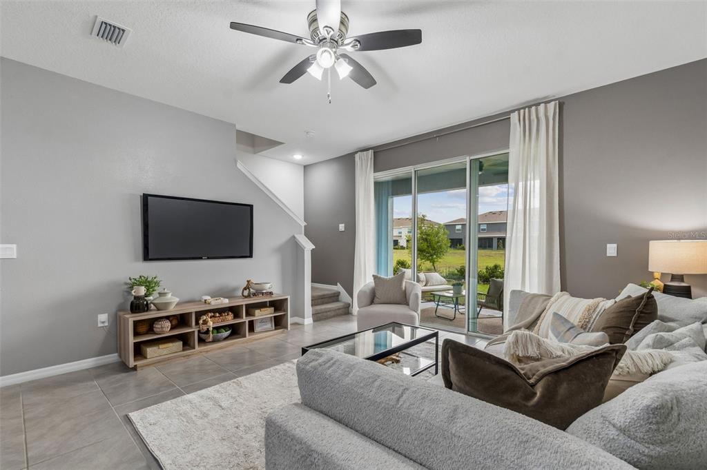 33083 Frosted Clover Way Wesley Chapel, FL 33545 - Photo 33 of 70 a living room with furniture and a flat screen tv