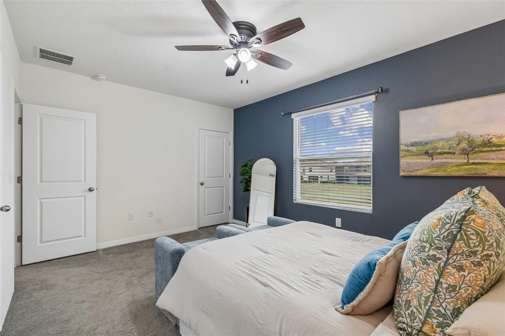 33083 Frosted Clover Way Wesley Chapel, FL 33545 - Photo 38 of 70 a bedroom with a large bed and a large window