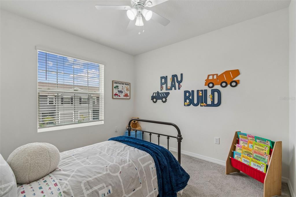 33083 Frosted Clover Way Wesley Chapel, FL 33545 - Photo 42 of 70 a bedroom with a bed and a painting on the wall