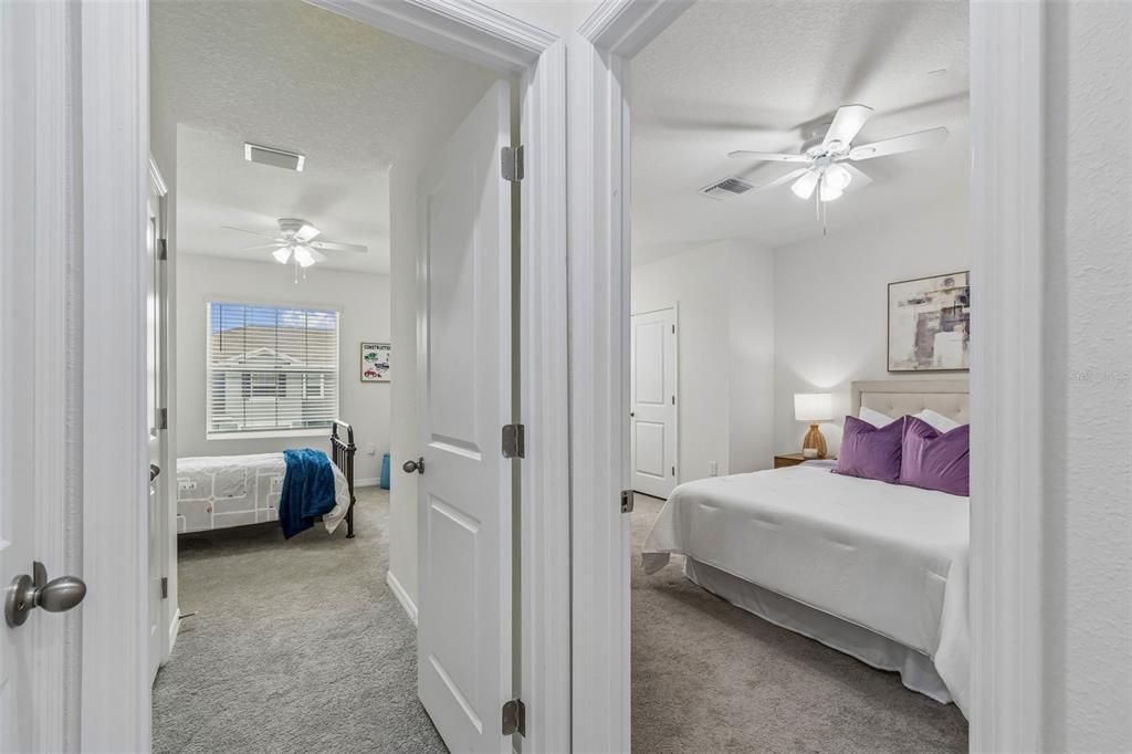 33083 Frosted Clover Way Wesley Chapel, FL 33545 - Photo 45 of 70 a bedroom with a bed and a chandelier