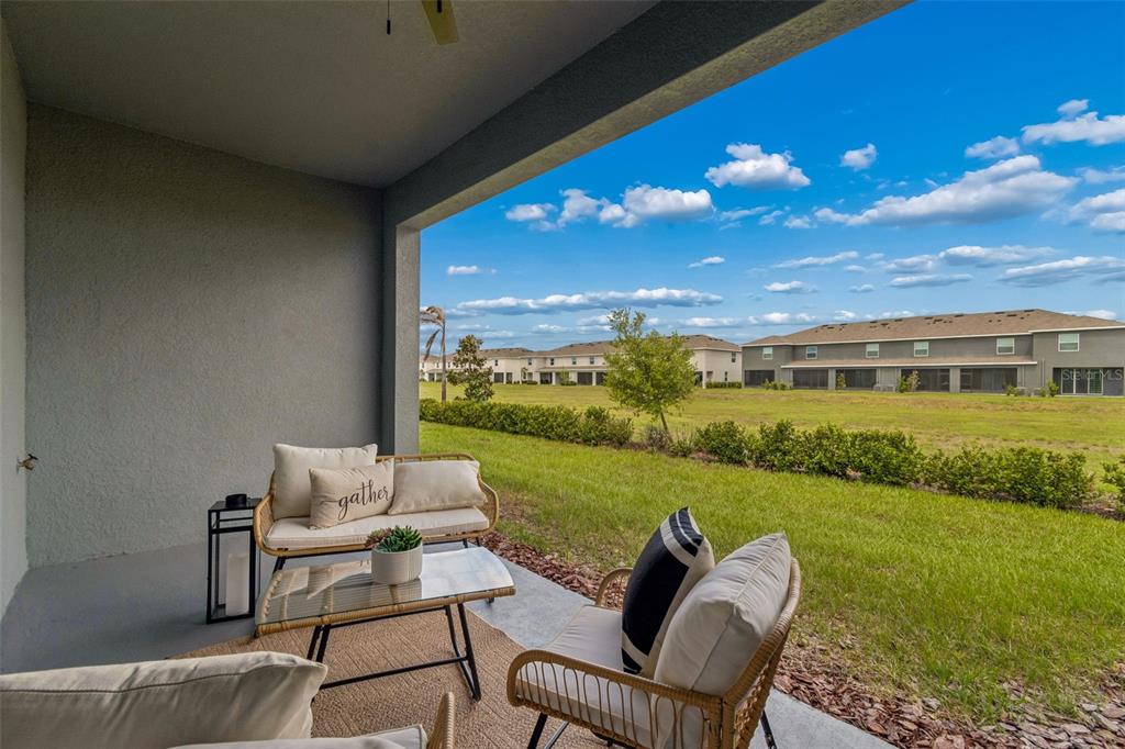 33083 Frosted Clover Way Wesley Chapel, FL 33545 - Photo 50 of 70 a balcony with furniture and garden view