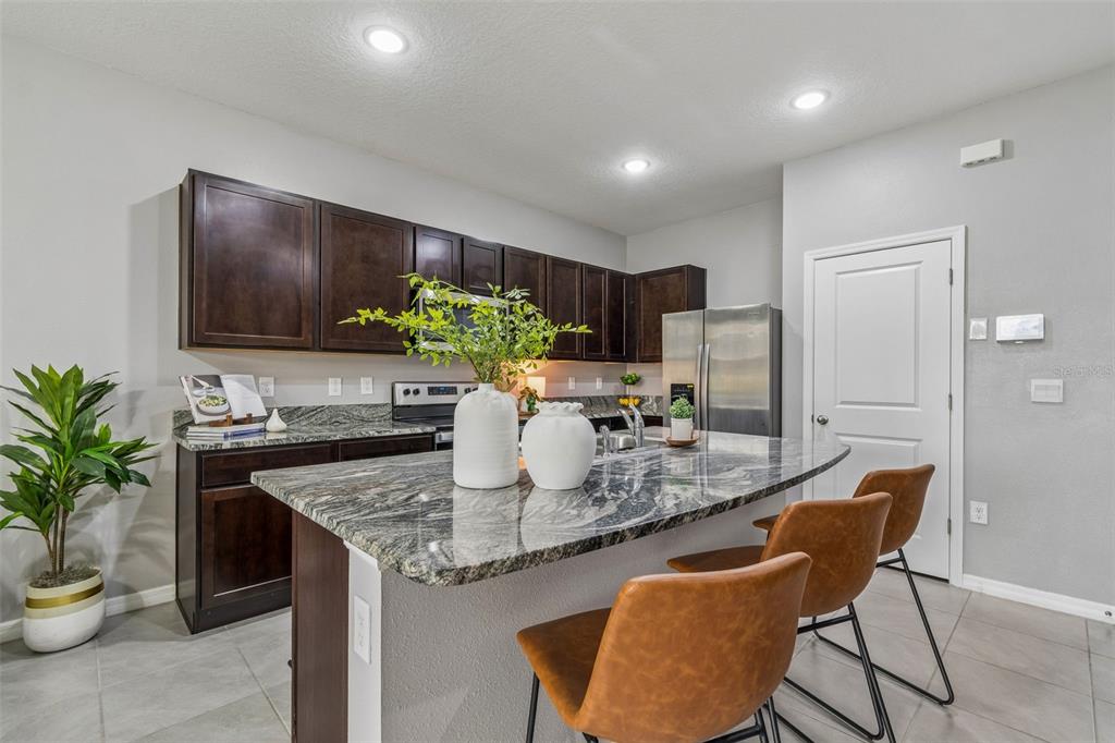 33083 Frosted Clover Way Wesley Chapel, FL 33545 - Photo 6 of 70 a kitchen with sink and refrigerator