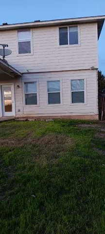 a view of a house with many windows and a yard