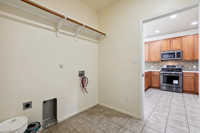 a kitchen with a refrigerator and a stove top oven