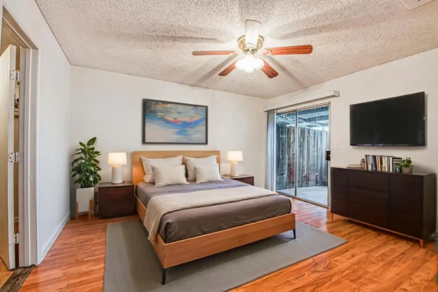 a bedroom with a bed and a flat screen tv