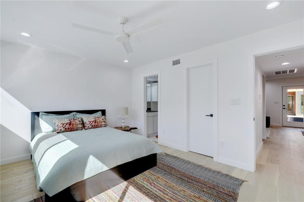 400 East 30th Street, Unit 204 Austin, TX 78705 - Photo 11 of 18 a bedroom with a bed and wooden floor