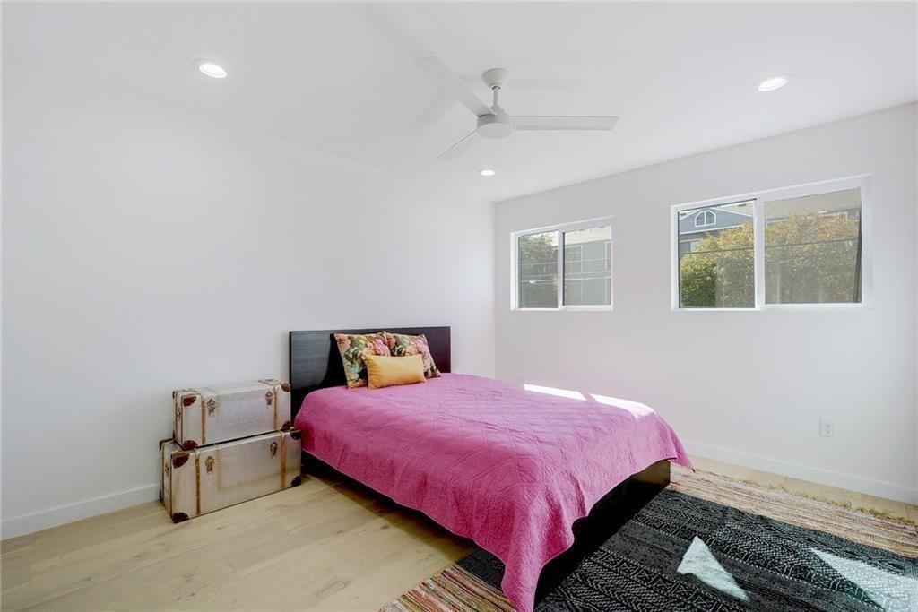 400 East 30th Street, Unit 204 Austin, TX 78705 - Photo 13 of 18 a bedroom with a bed and wooden floor
