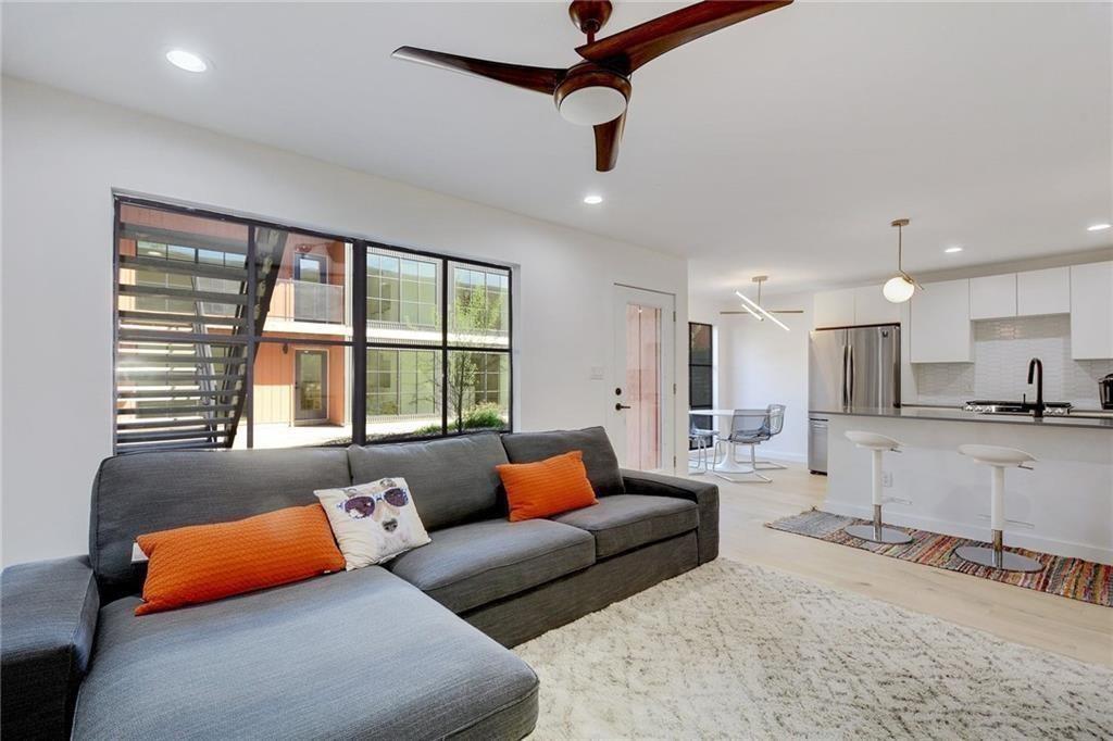 400 East 30th Street, Unit 204 Austin, TX 78705 - Photo 5 of 18 a living room with furniture and a large window