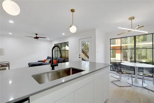 a kitchen with a sink and a large window