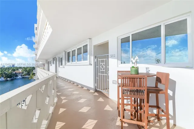 a view of a porch with furniture and a yard