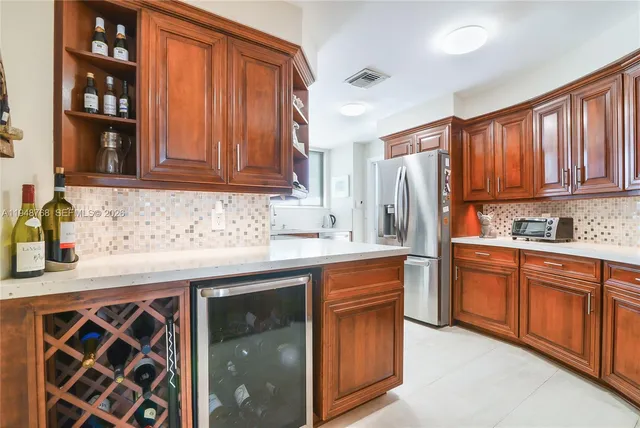 a kitchen with stainless steel appliances granite countertop a refrigerator and a sink