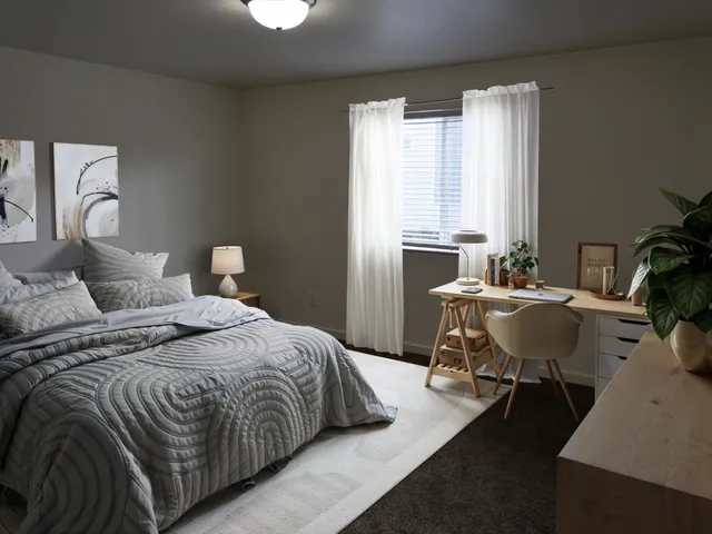 a bedroom with a bed and chair with window