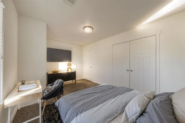 a bedroom with a bed and a flat screen tv