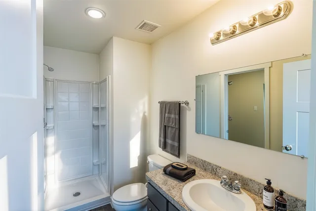 a bathroom with a sink toilet and shower