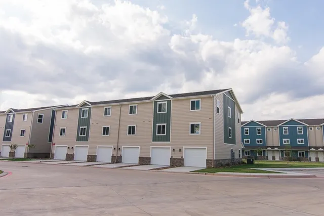 a city view with tall buildings and a big yard