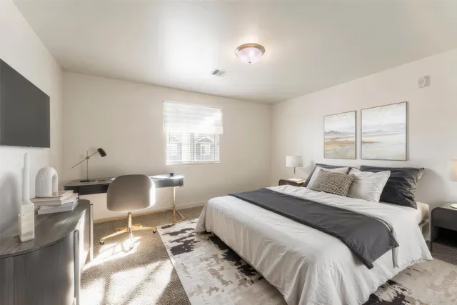 a bedroom with a bed and a flat screen tv