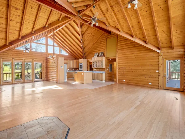 a view of a patio with table and chairs and wooden floor