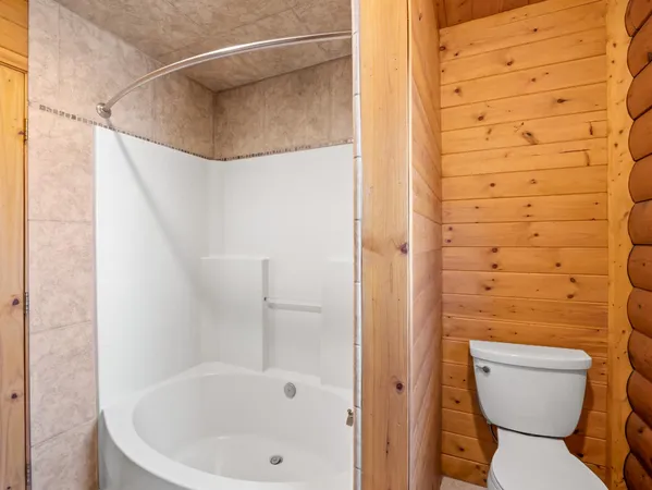 a bathroom with a toilet and shower