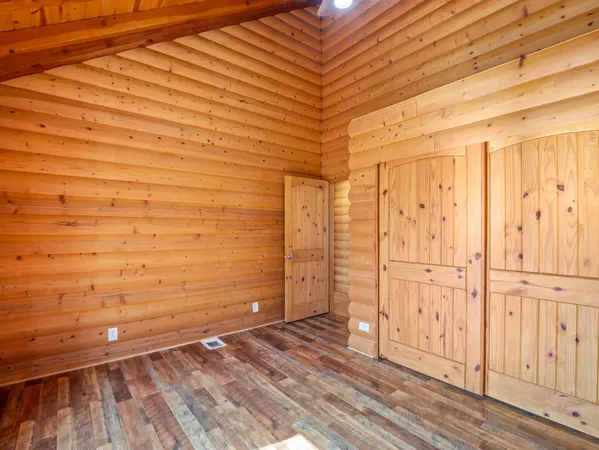 a view of a room with wooden floor