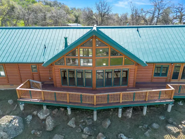 a view of a house with a yard and sitting area