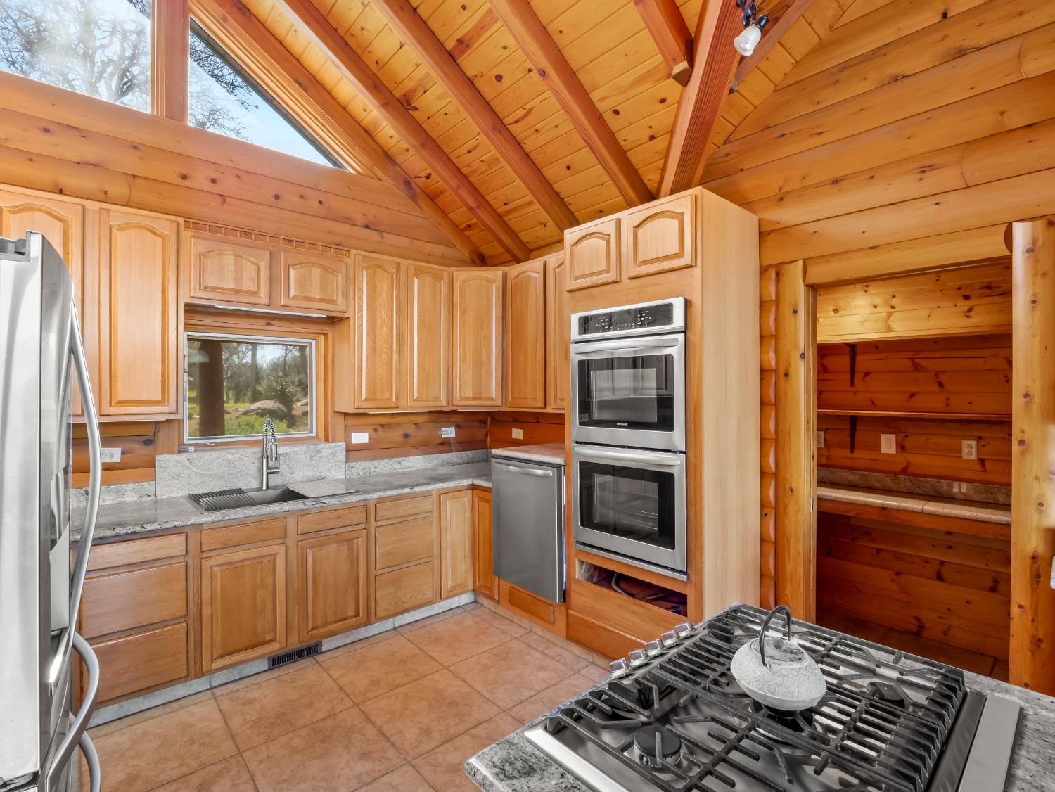 37678 Cardinal Lane Squaw Valley, CA 93675 - Photo 48 of 65 a kitchen with a stove a sink and a microwave