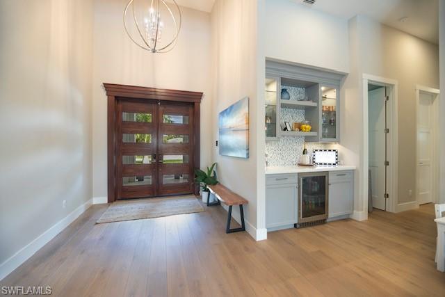 Undisclosed Address Naples, FL 34110 - Photo 13 of 18 a open kitchen with a sink and dishwasher a stove top oven with wooden floor
