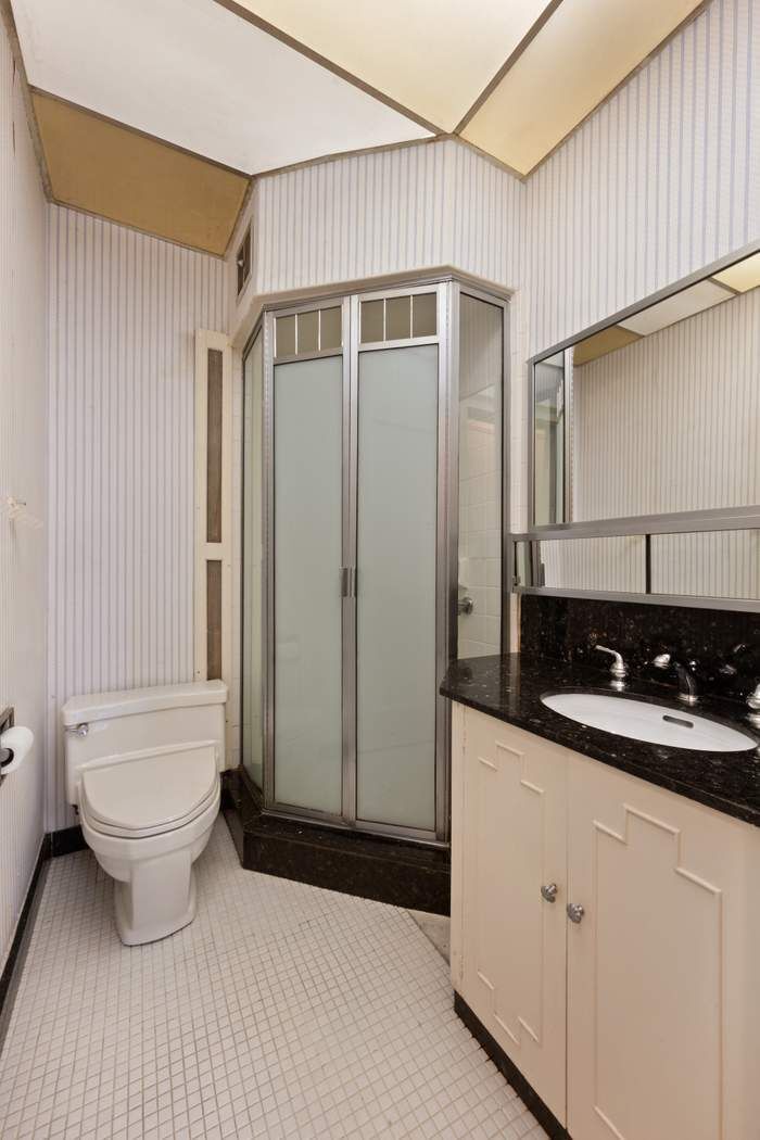 103 East 84th Street, Unit 6B Manhattan, NY 10028 - Photo 10 of 19 a bathroom with a sink a toilet and shower