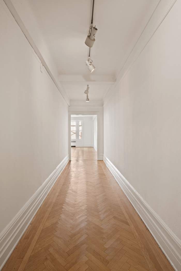103 East 84th Street, Unit 6B Manhattan, NY 10028 - Photo 17 of 19 wooden floor in an empty room with a window