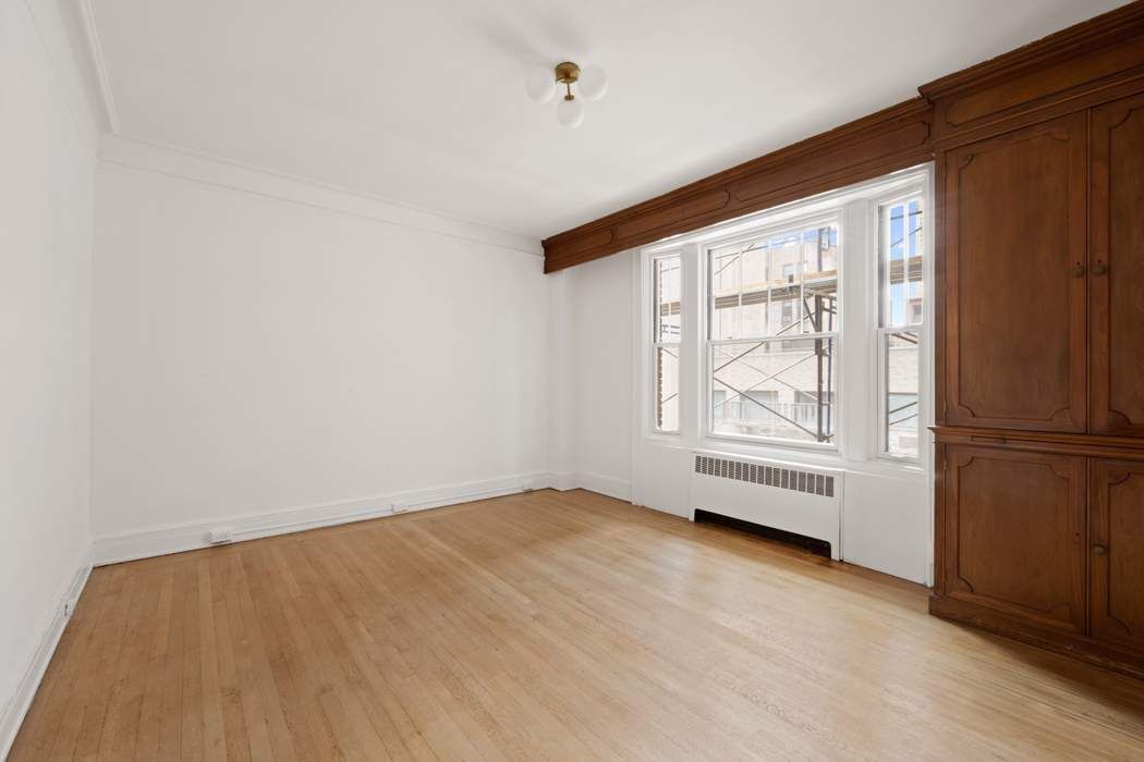 103 East 84th Street, Unit 6B Manhattan, NY 10028 - Photo 6 of 19 an empty room with windows