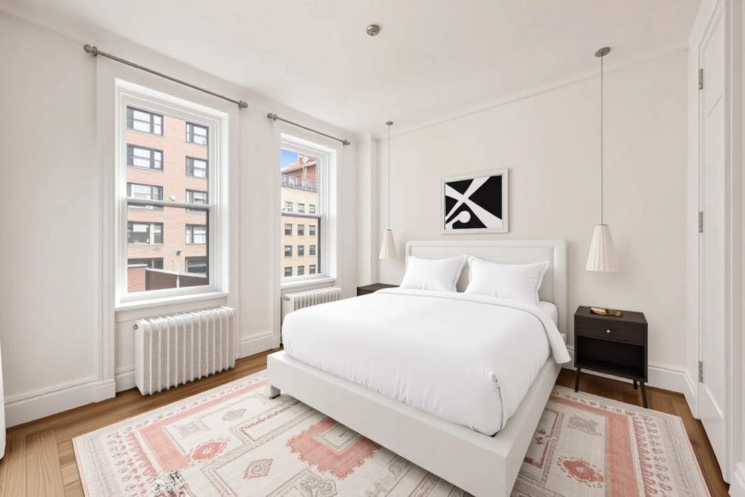 103 East 84th Street, Unit 6B Manhattan, NY 10028 - Photo 8 of 19 a bedroom with a large bed and a window