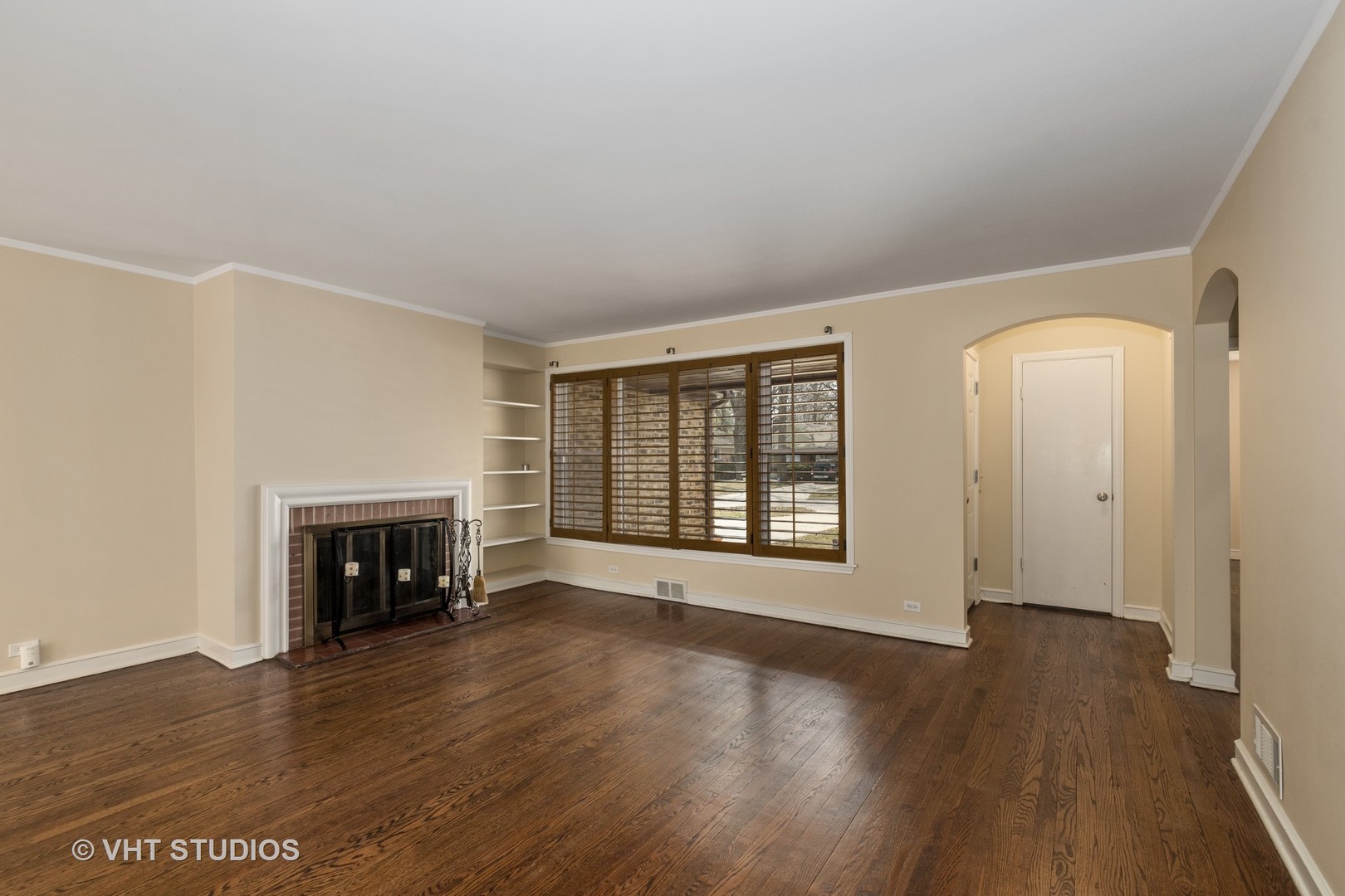 299 Barberry Road Highland Park, IL 60035 - Photo 2 of 17 an empty room with wooden floor fireplace and windows