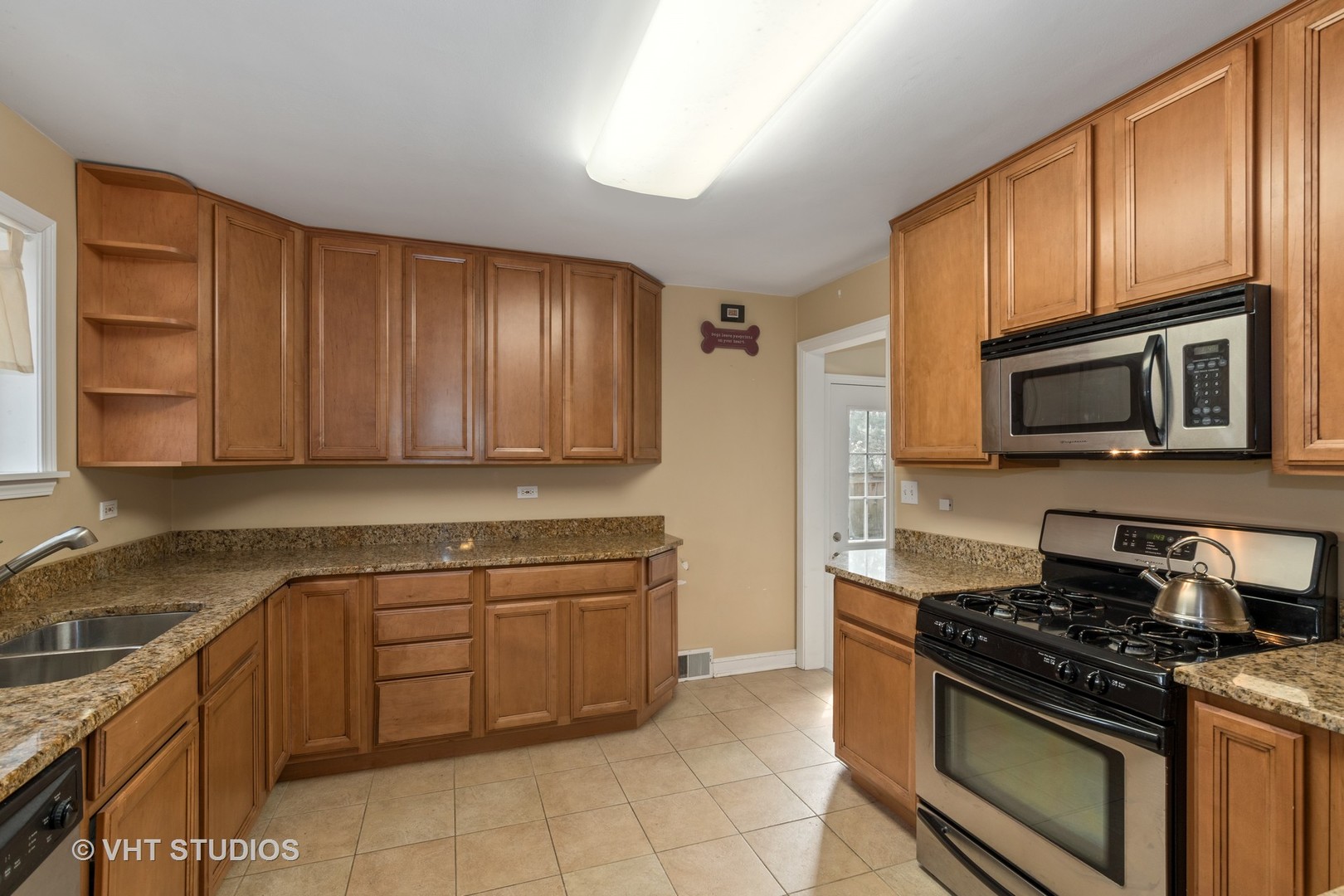 299 Barberry Road Highland Park, IL 60035 - Photo 4 of 17 a kitchen with granite countertop wooden cabinets and stainless steel appliances