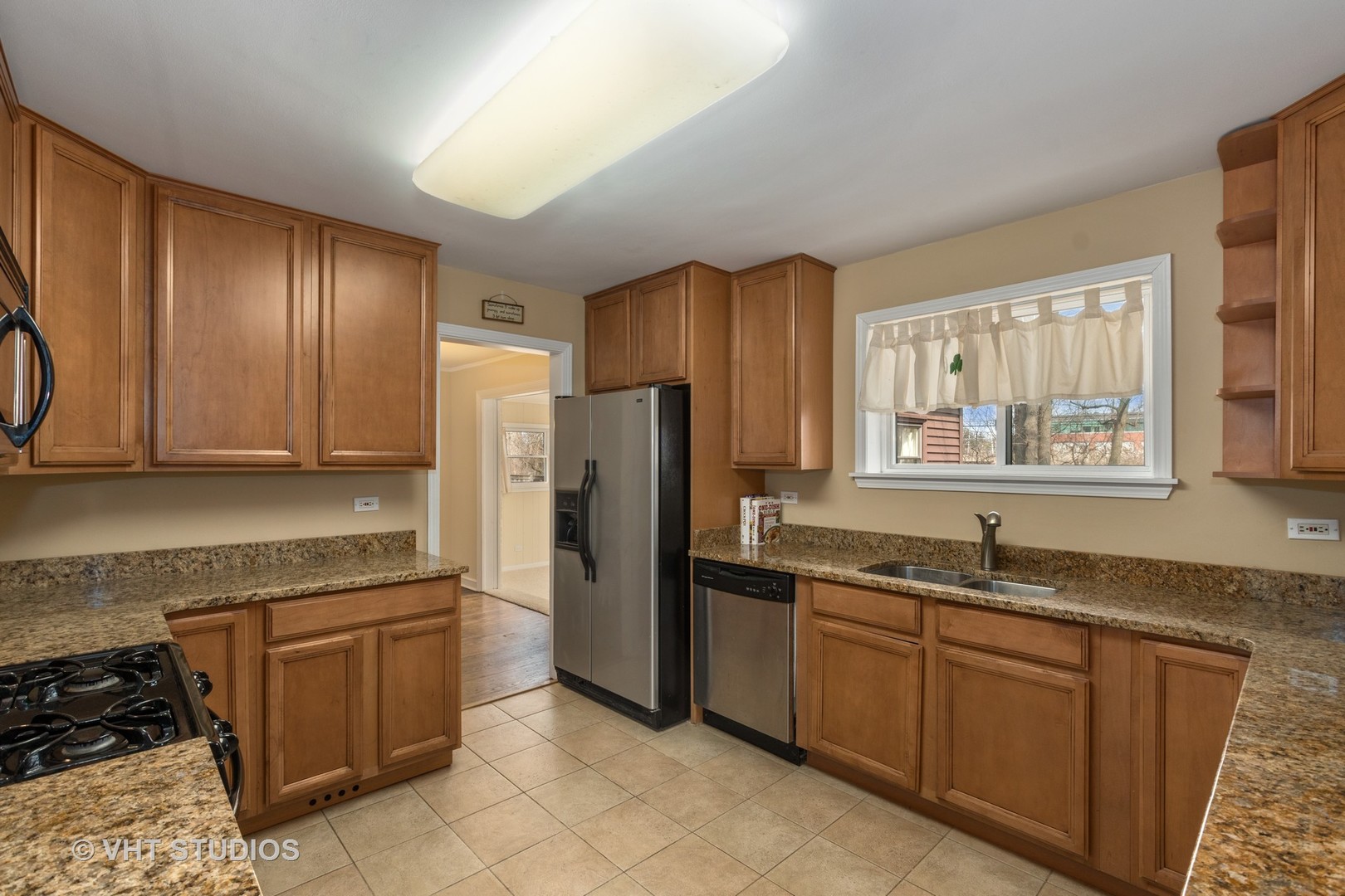 299 Barberry Road Highland Park, IL 60035 - Photo 5 of 17 a kitchen with granite countertop stainless steel appliances a refrigerator sink and microwave
