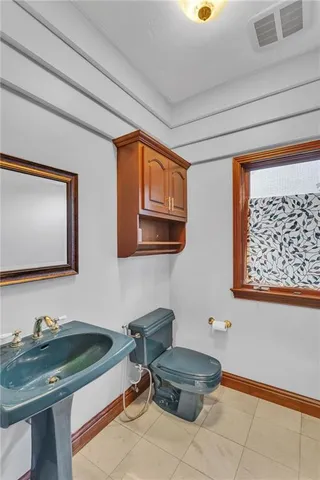 a bathroom with a sink a mirror and a toilet