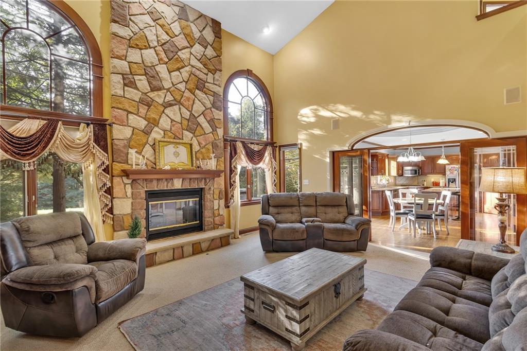 5010 Prides Court Murrysville, PA 15668 - Photo 13 of 49 a living room with furniture a fireplace and a large window