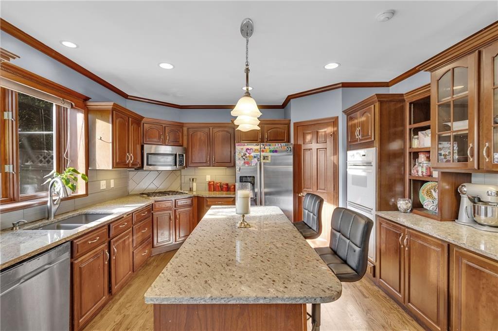 5010 Prides Court Murrysville, PA 15668 - Photo 20 of 49 a kitchen with stainless steel appliances granite countertop sink stove top oven and refrigerator