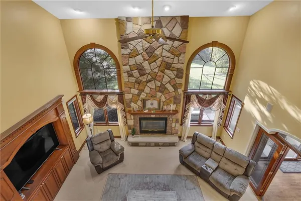 a living room with fireplace furniture and a wooden floor